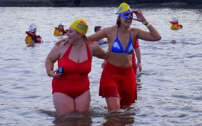 Girls at the Loony Dook including Two Haggis Adventurers take a dip in the frigid waters
