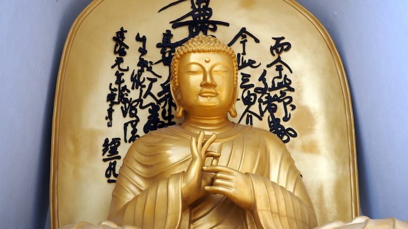 Golden Buddha with a distinct hand pose in Pokhara, Nepal 