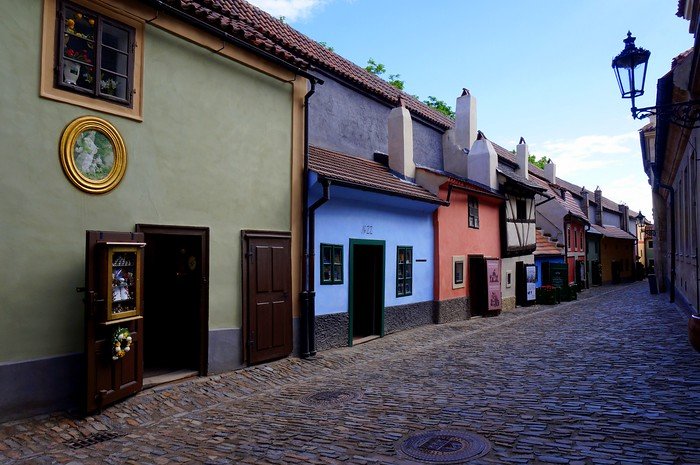 Charming pastel-coloured cottages lining the cobblestone Golden Lane inside Prague Castle in Prague, Czech Republic, showcasing medieval architecture and historic artisan houses