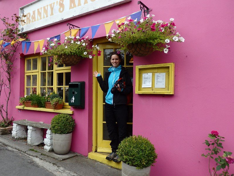 Granny's Kitchen Cafe in Cashel with bright pink exterior and my friends waving to our Ireland girls road trip group! 