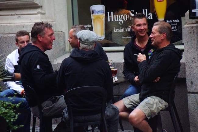 Group of Finnish men smoking and drinking on the street in Helsinki, Finland 