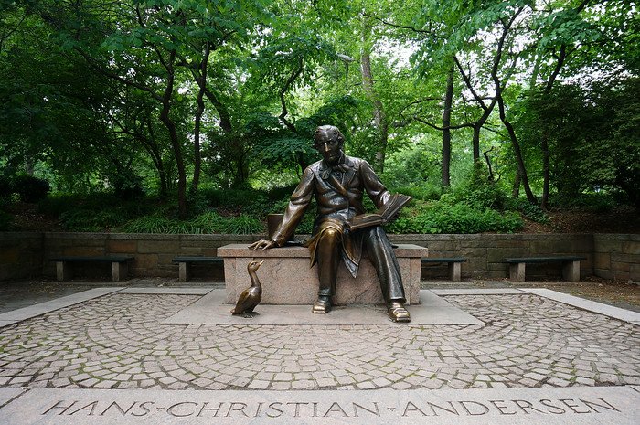 A bronze sculpture of Hans Christian Andersen seated with an open book and a duck by his side, located in Central Park, New York City. This literary monument celebrates the famous Danish author and is a popular stop for visitors exploring the park