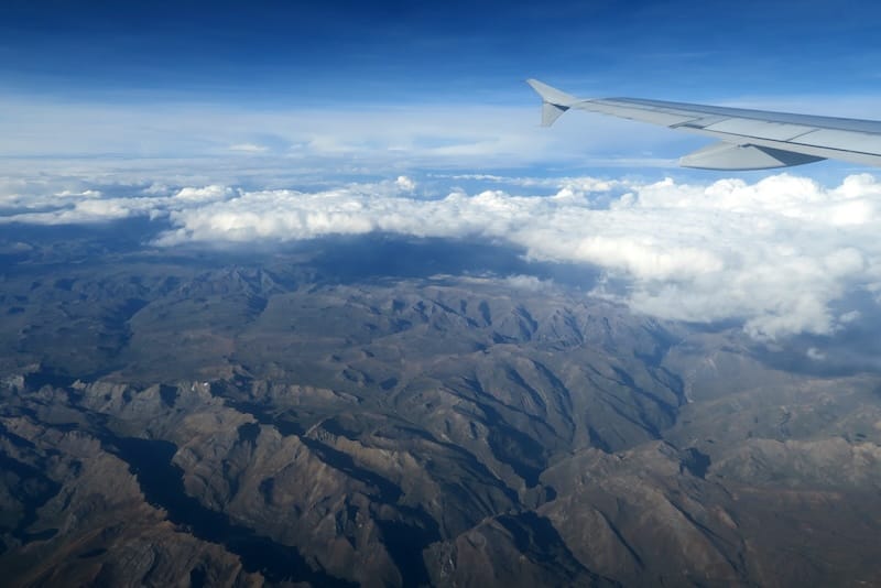 High altitude mountain ranges as we fly to Cusco, Peru from outside of our plane window