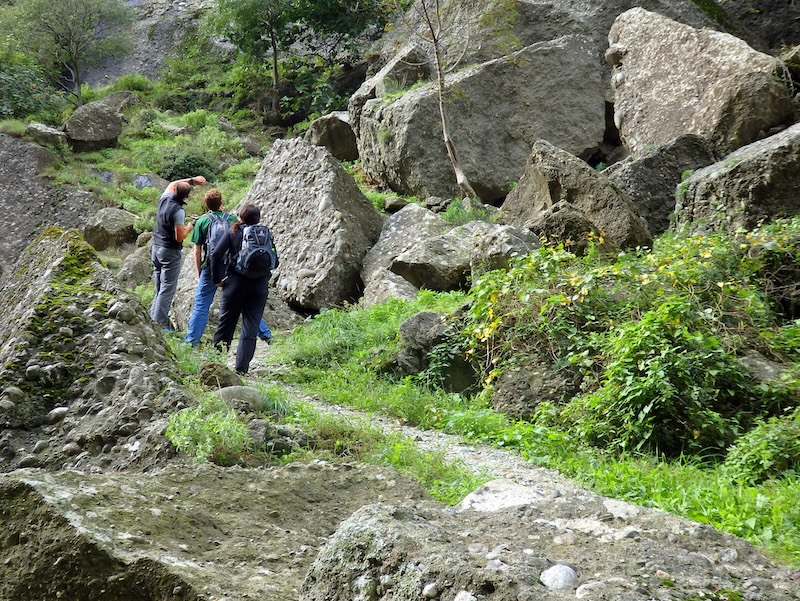Hikers admiring distinct rock formations on Meteora hike in Greece 