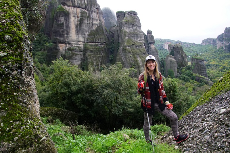 Hiking in Meteora to reach abandoned monasteries in Greece with That Backpacker Audrey Bergner posing with hiking stick in hand