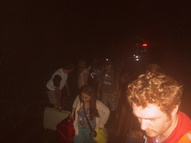 Hiking through a dark tunnel after our train derailed en route to Chiang Mai with flash illuminating Nomadic Samuel but darkness otherwise