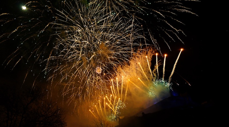 Hogmanay fireworks exploding in all directions at night in Edinburgh, Scotland 