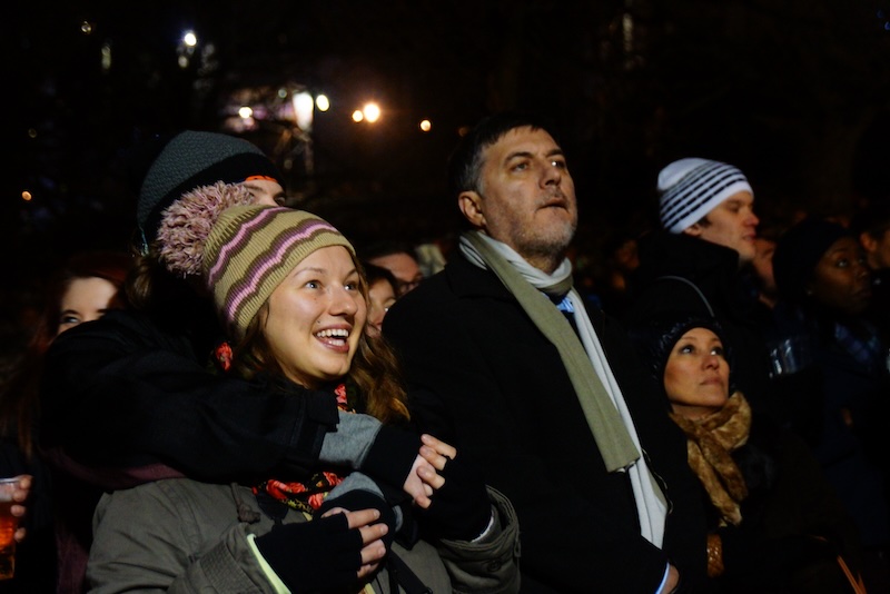 Hogmanay spectators enjoying musical performance with nothing but smiles in Edinburgh, Scotland 