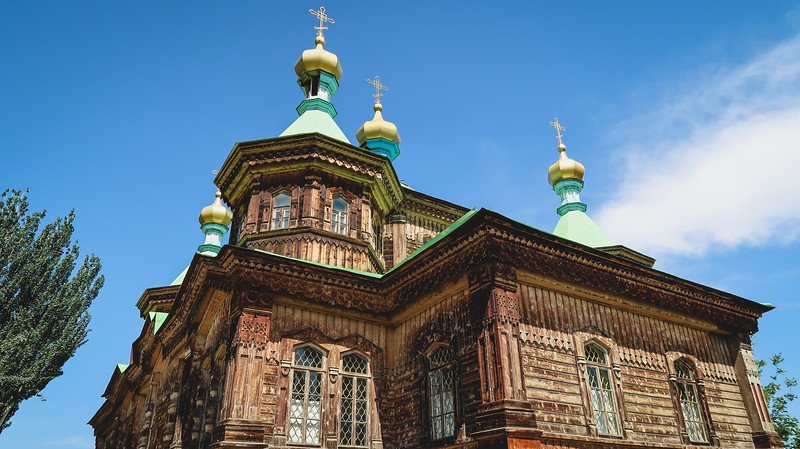 Holy Trinity Russian Orthodox Church in Karakol, Kyrgyzstan with its unique wooden structure and ornate roof details 