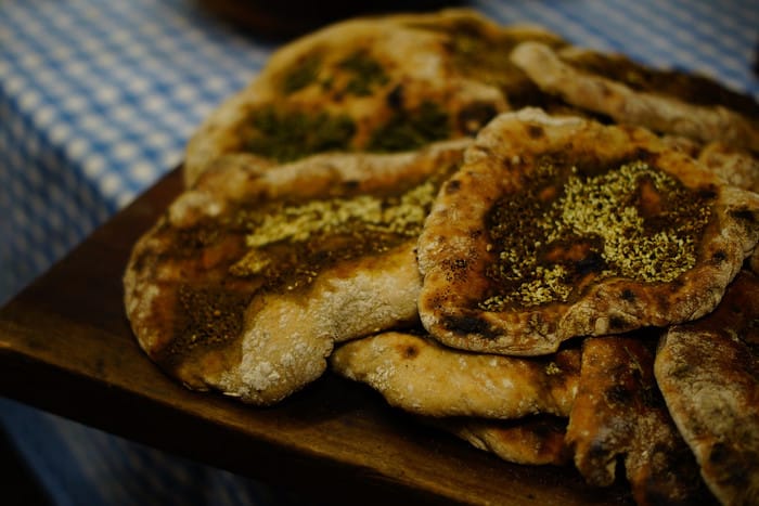 Homemade pita bread with zaatar as a delicious food to try in Israel 