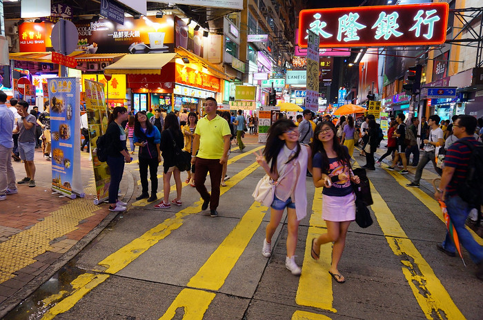 Hong Kong Travel Guide for first-time visitors: Mong Kok at night with a plethora of pedestrians pounding the pavement in Hong Kong