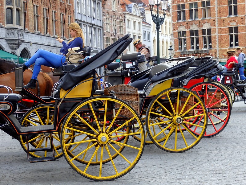 Horse-drawn carriage rides are unique way to see the historic city centre in Bruges, Belgium Horse-drawn carriage rides are unique way to see the historic city centre in Bruges, Belgium