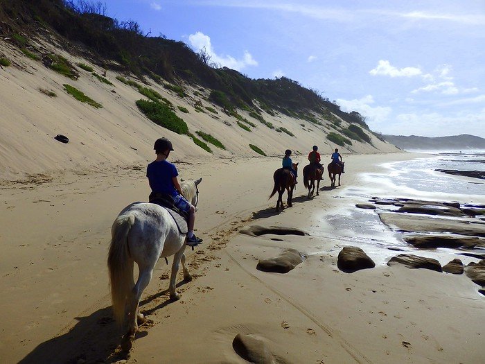 Horse riding on the beach located in Cintsa while backpacking South Africa on an adventure travel trip of a lifetime