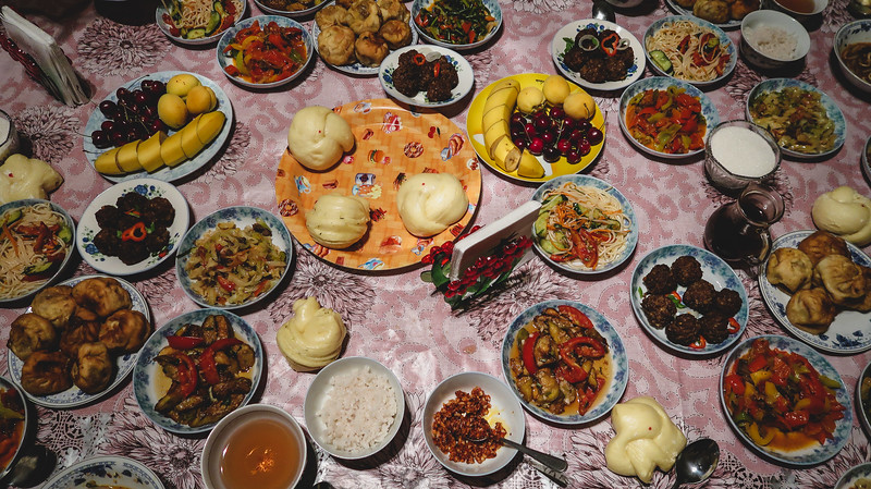 Huge Kyrgyz cuisine feast laid out on a traditional table in Karakol, Kyrgyzstan with a huge spread of food on offer showcasing generous hospitality 