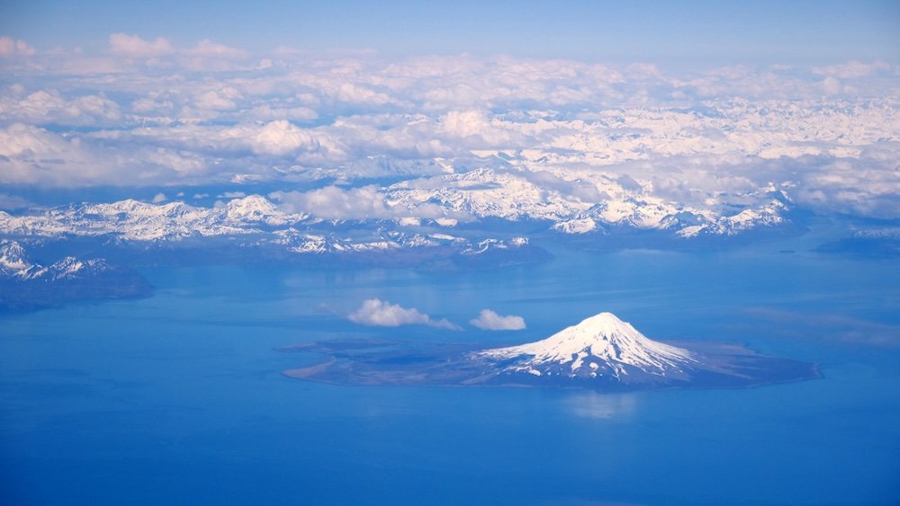 Incredible ice capped mountain and volcanic island views flying to Japan 
