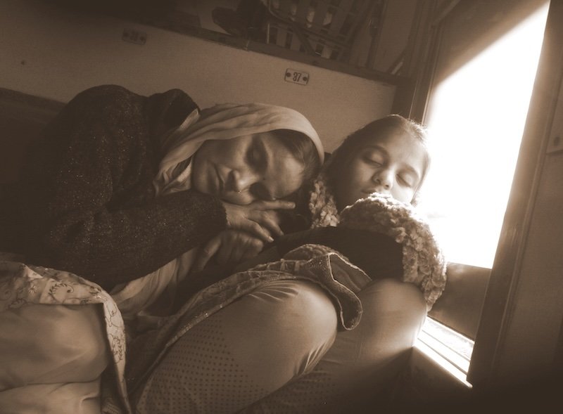 Indian family sleeping together on the train in India Indian family sleeping together on the train in India
