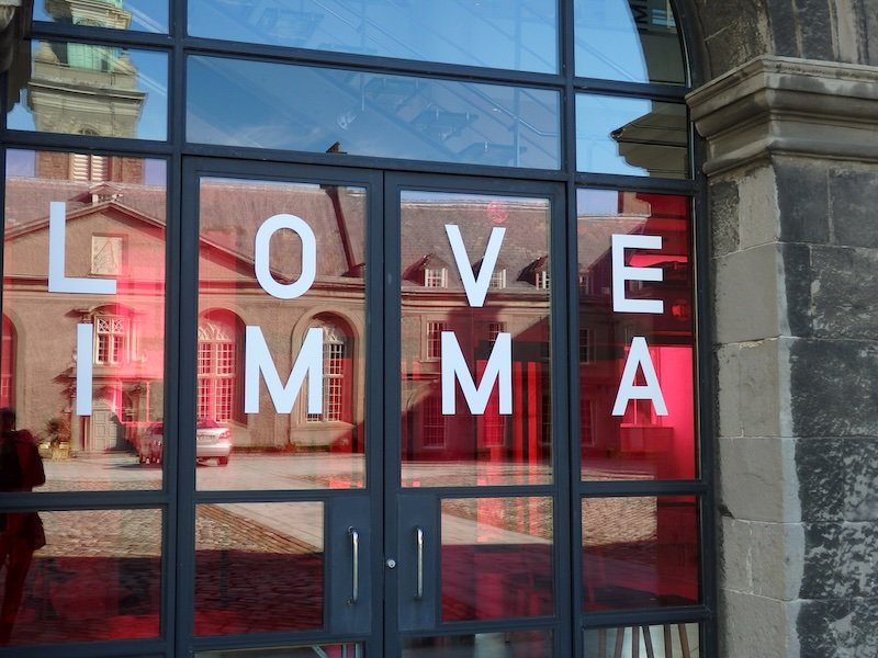 Entrance of the Irish Museum of Modern Art in Dublin, Ireland with glass doors displaying LOVE IMMA and reflections of Royal Hospital Kilmainham