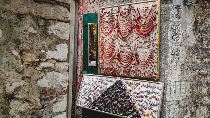 Jewellery in Rovinj displayed against the historic city walls making for a unique blend in Croatia 