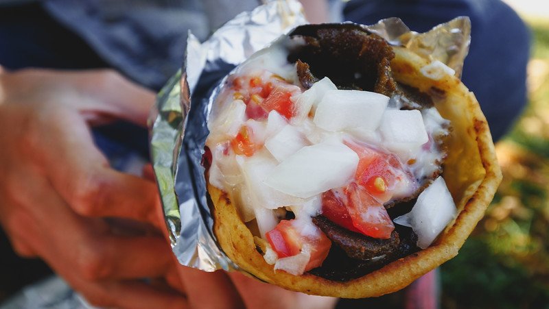 Johnny K's Authentic Donairs macro details loaded to the brim with shaved meat, oninions, tomatoes and tonnes of special sauce in Halifax