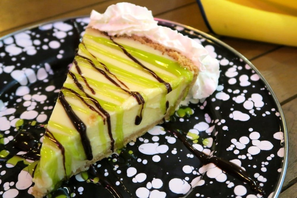 Key Lime Pie with Whipped Cream at The Stoned Crab and intersecting green and chocolate drizzle on top