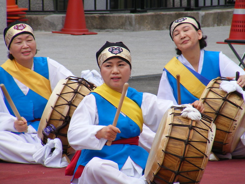 Korean Ladies Engaging In A Traditional Drumming Performance in Seoul, South Korea wearing traditional Korean attire 