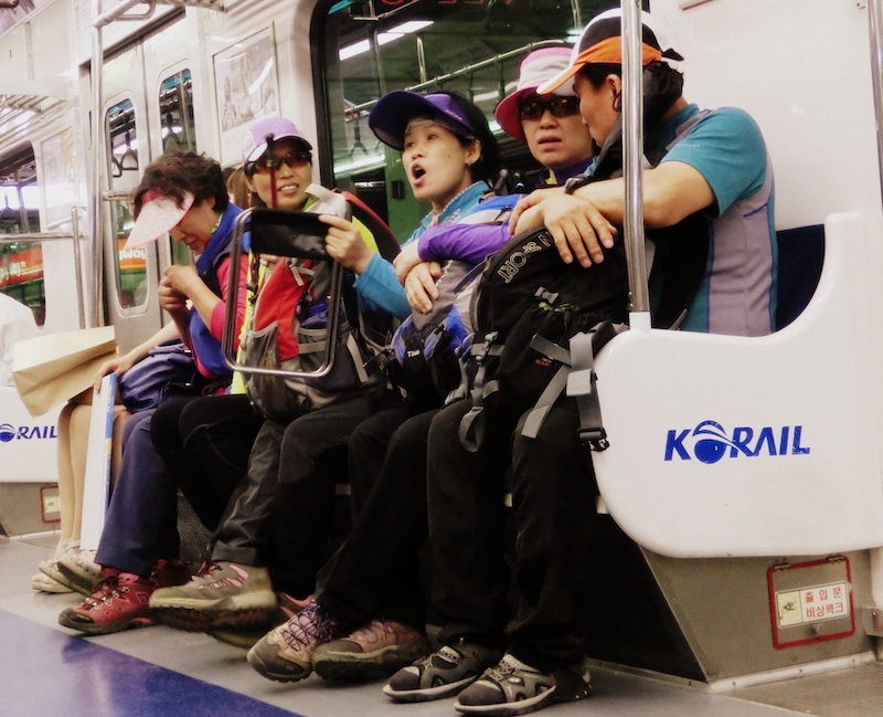 Korean ladies wearing hiking clothes taking the metro in Seoul, Korea 