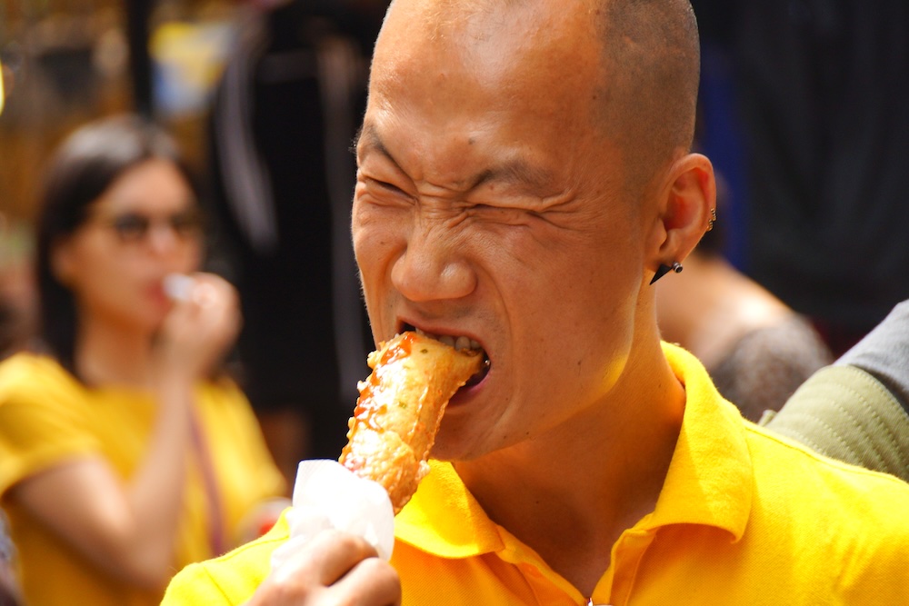Korean man eating street food in Seoul 