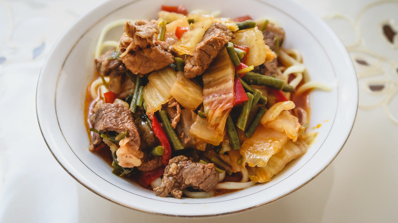 Kyrgyz noodles and meat dish learning to make the popular Uyghur dish from scratch in Karakol, Kyrgyzstan 