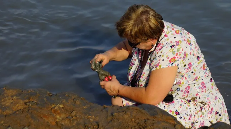 Lady gathering mud from the Dead Sea in Israel 