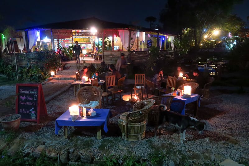Lakefront bars in Pokhara lit up at night with guests enjoying a relaxing evening in Nepal