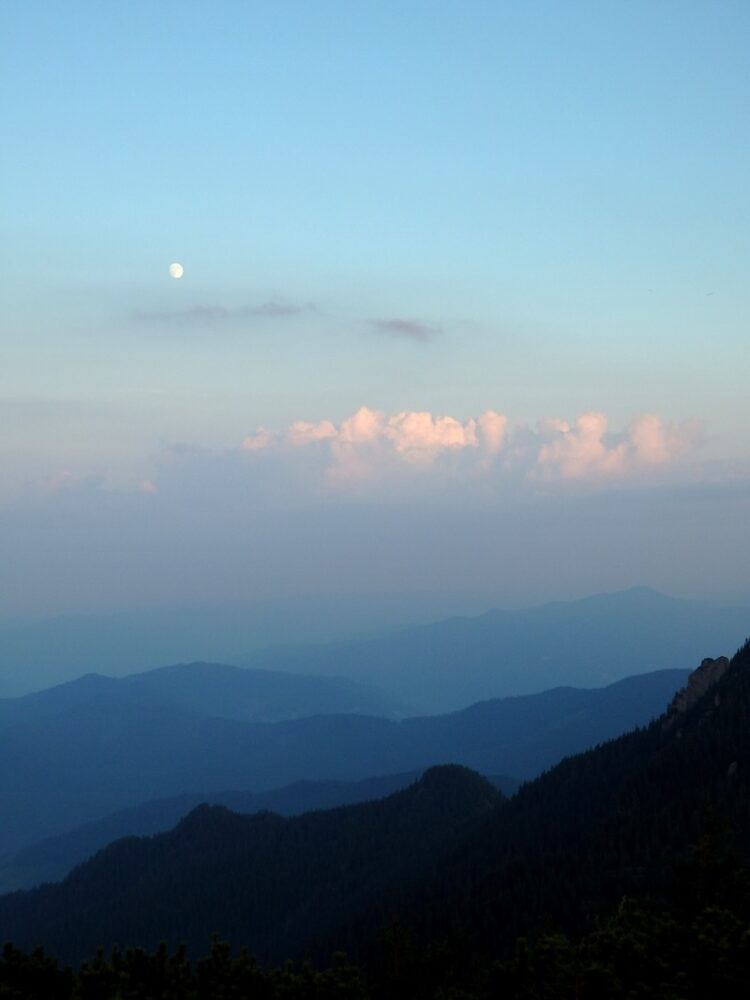 Layer upon layer upon layer of mountains during blue hour hiking in Romania 