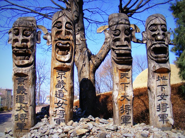 Learning about Korean culture while working as an English teacher viewing Korean wooden sculptures that look like exaggerated totem poles 