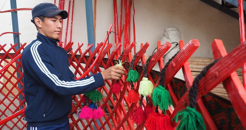 Learning how to build a yurt in Kyzyl-Tuu, Kyrgyzstan adding decorative touches