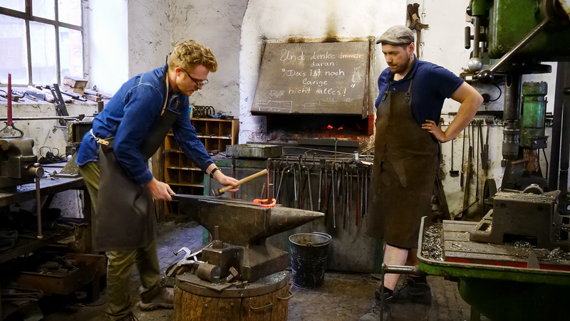Learning to forge at Burgenlandschmiede is Nomadic Samuel as an apprentice for the day with local German talent to help mold his future