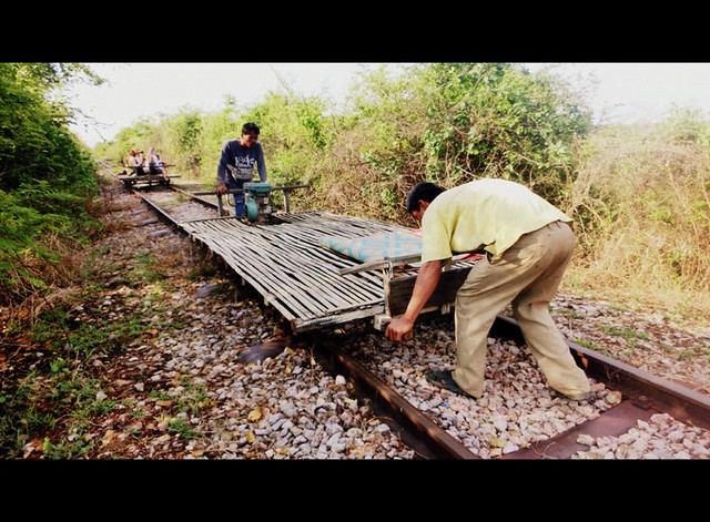 Lifting the bamboo train off the tracks so others can pass was a common occurrence during our ride in Cambodia in Battambang