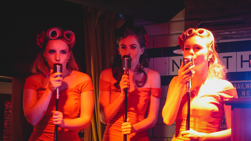 Live performance in London at night at Cahoots with vintage style performance and performers on stage 