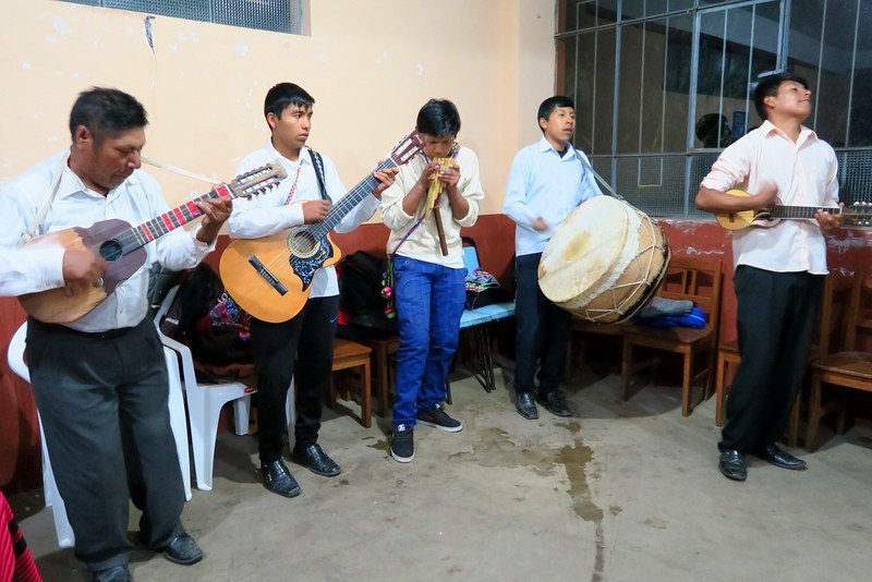 Local band playing at the dance hall in Amantani with guitars and traditional drums and singing on Lake Titicaca, Peru 