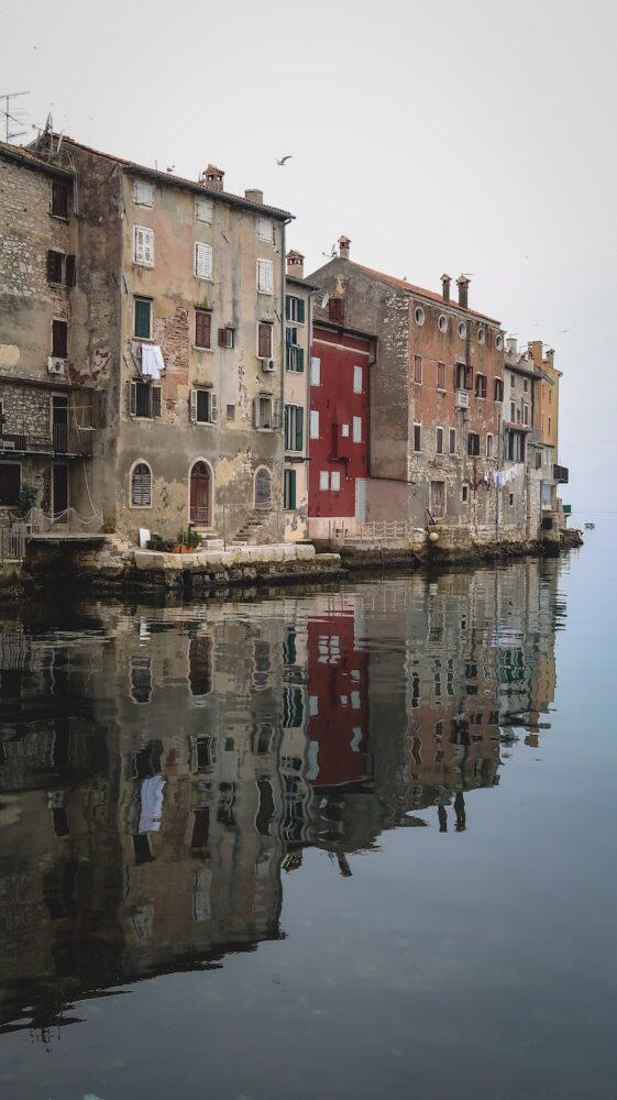 Local historic buildings in Rovinj reflection in the water in Croatia 