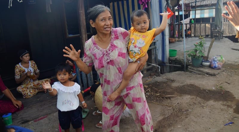 Local Vietnamese lady and baby boy waving goodbye to us on our Mekong Delta Tour in Vietnam 
