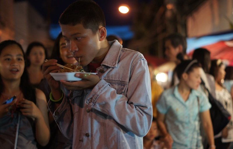 Locals eating Thai street food at the Saturday Night Market in Chiang Mai, Thailand 