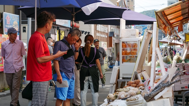 Locals wearing shorts and t-shirts during early autumn weather in Hakodate, Japan 