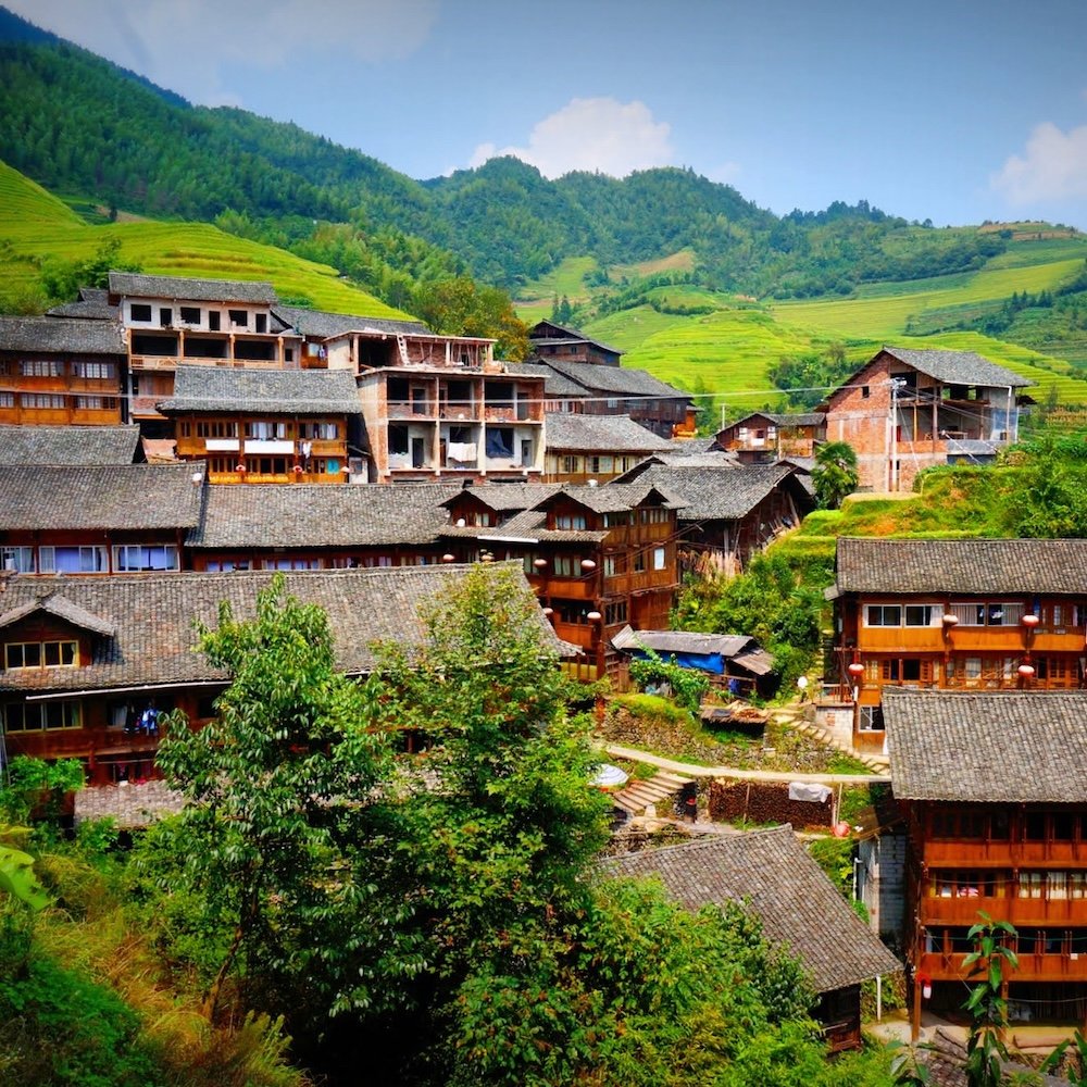 Longsheng Rice Terrace views in China featuring traditional roof views and mountain backdrop as the ideal scene 
