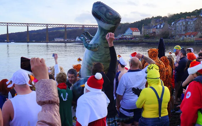 Loony Dookers and an inflatable dinosaur ready to go into the Firth of Forth on a chilly day in Scotland 