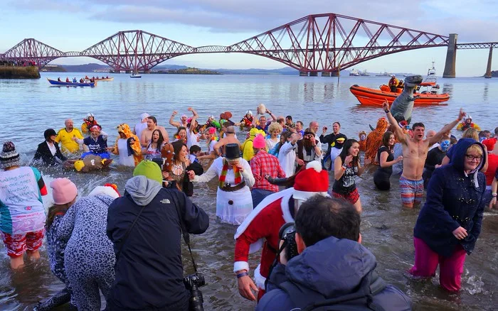Loony Dookers jumping into the freezing waters and enjoying the festivities at this quirky event in Scotland to celebrate new year 