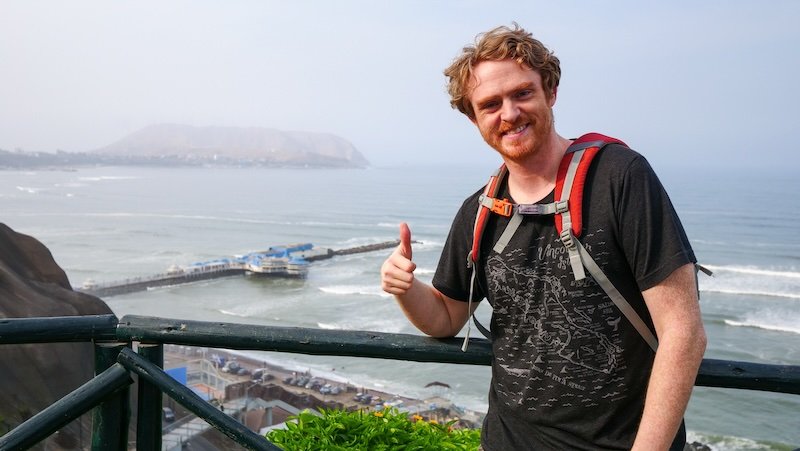 Loving the views from Miraflores along the coastline of Lima, Peru is Nomadic Samuel with thumbs up 