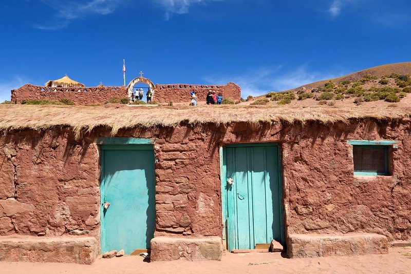 Adobe houses with turquoise doors in the traditional Andean village of Machuca near El Tatio Geysers in the Atacama Desert, Chile
