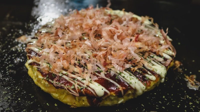 Making our very own Okonomiyaki in Osaka, Japan for the ultimate comfort meal on the grill at the table 