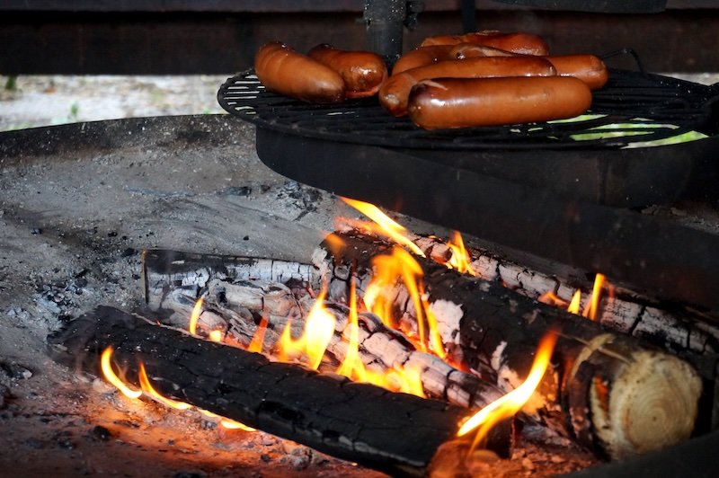 Making sausages over an open fire pit is every man's right in Finland to enjoy nature 