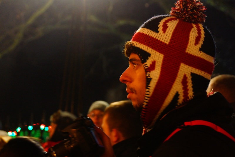 Man wearing warm knit beanie at Hogmanay for New Year's celebration in Edinburgh, Scotland 