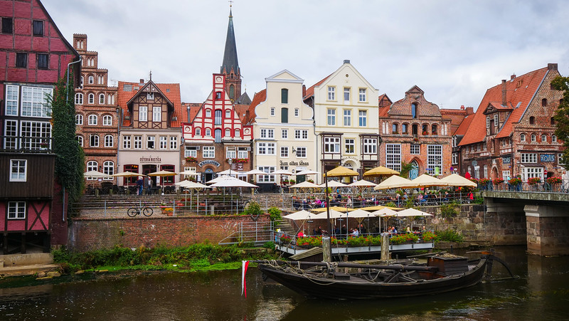 Medieval buildings line the banks of the Ilmenau River in Lüneburg, Germany offering a charming view of the city